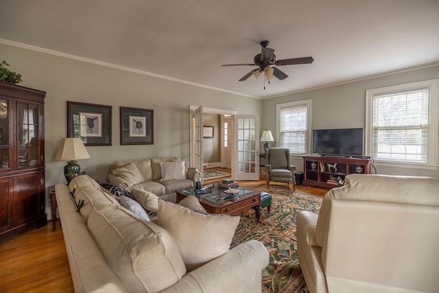 living room featuring french doors, ceiling fan, crown molding, and hardwood / wood-style floors