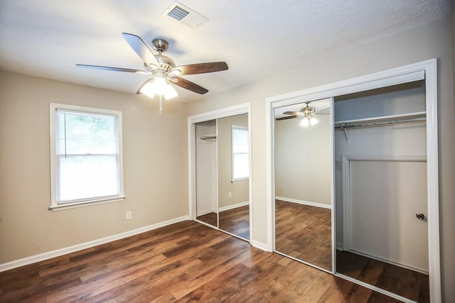 4552 Bettys Branch Way, Evans, GA 30809 - unfurnished bedroom with multiple windows, two closets, wood finished floors, and visible vents