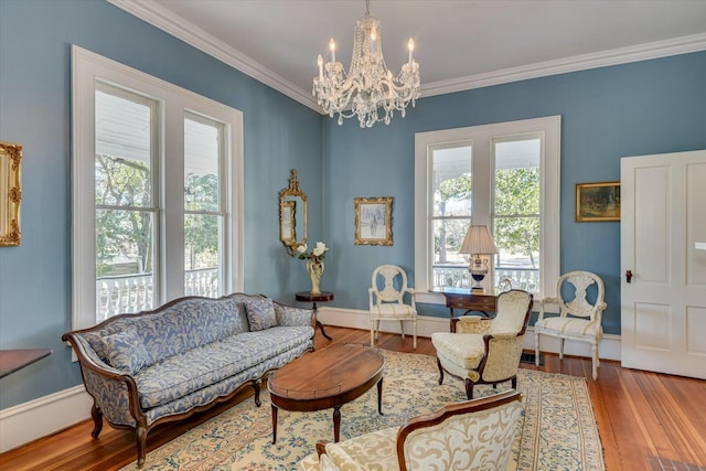 sitting room featuring crown molding, light hardwood / wood-style floors, and a wealth of natural light