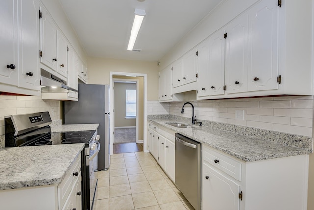 3831 Highpointe Dr, Hephzibah, GA 30815 - kitchen with appliances with stainless steel finishes, under cabinet range hood, white cabinetry, and decorative backsplash