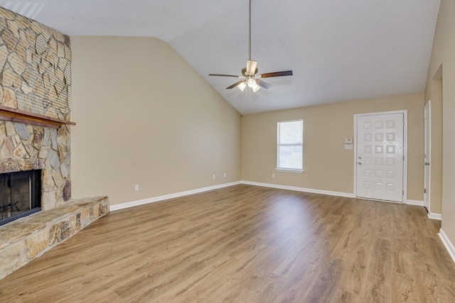 3831 Highpointe Dr, Hephzibah, GA 30815 - unfurnished living room featuring lofted ceiling, a ceiling fan, a fireplace, and wood finished floors