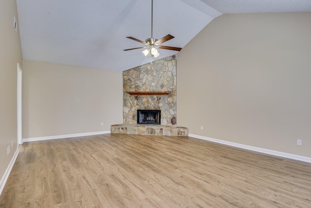 3831 Highpointe Dr, Hephzibah, GA 30815 - unfurnished living room with a ceiling fan, wood finished floors, a stone fireplace, and high vaulted ceiling