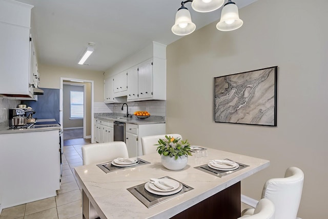 3831 Highpointe Dr, Hephzibah, GA 30815 - kitchen featuring light tile patterned floors, white cabinetry, backsplash, light countertops, and dishwasher