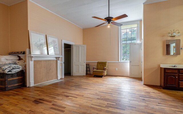 bedroom featuring ceiling fan, ornamental molding, and light hardwood / wood-style flooring