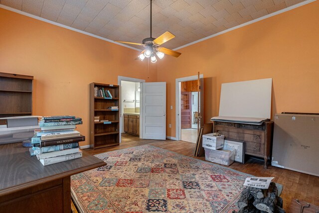 office with ceiling fan, crown molding, and dark wood-type flooring