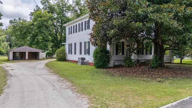 view of front of home featuring a front lawn and cooling unit