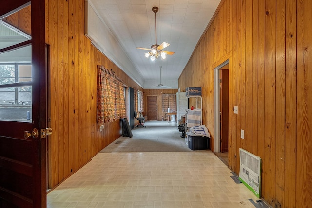 hall with wooden walls and crown molding