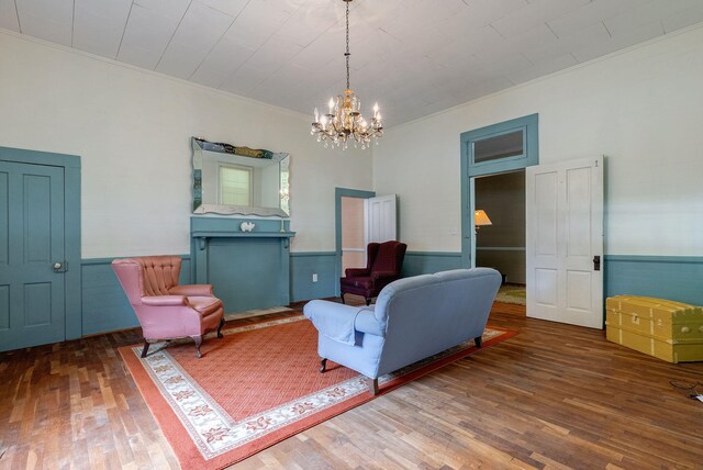 living area featuring hardwood / wood-style flooring, ceiling fan, and ornamental molding