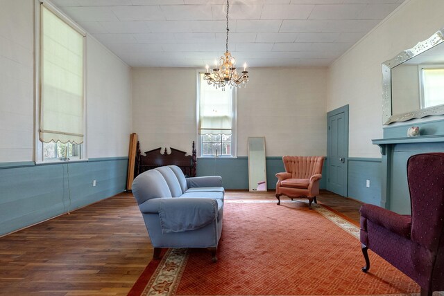 sitting room with a chandelier and dark hardwood / wood-style flooring