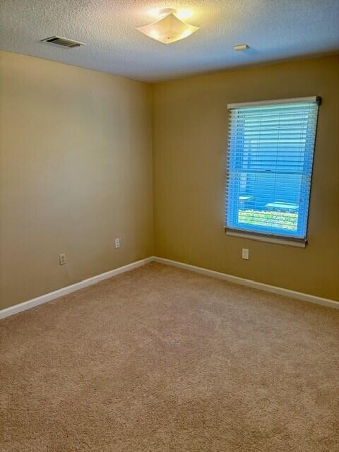 2949 Hillcreek Dr, Augusta, GA 30909 - spare room featuring a textured ceiling, light colored carpet, and baseboards