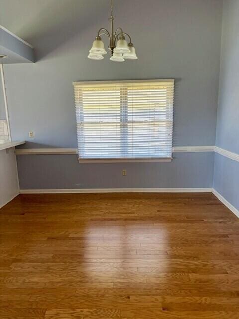 2949 Hillcreek Dr, Augusta, GA 30909 - unfurnished dining area featuring a chandelier, wood finished floors, and lofted ceiling