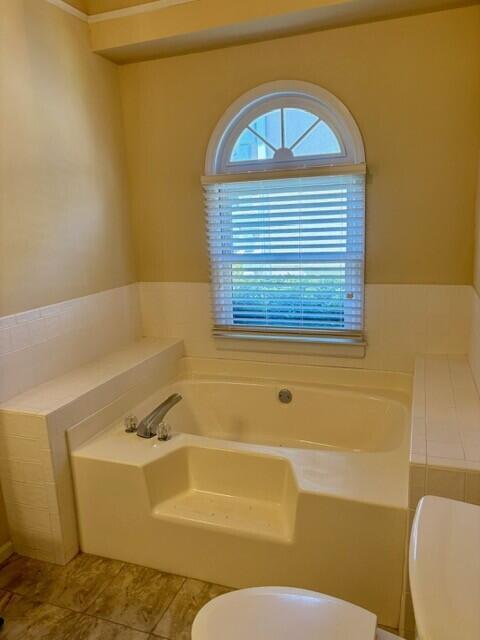 2949 Hillcreek Dr, Augusta, GA 30909 - bathroom featuring toilet, a bath, and tile patterned floors