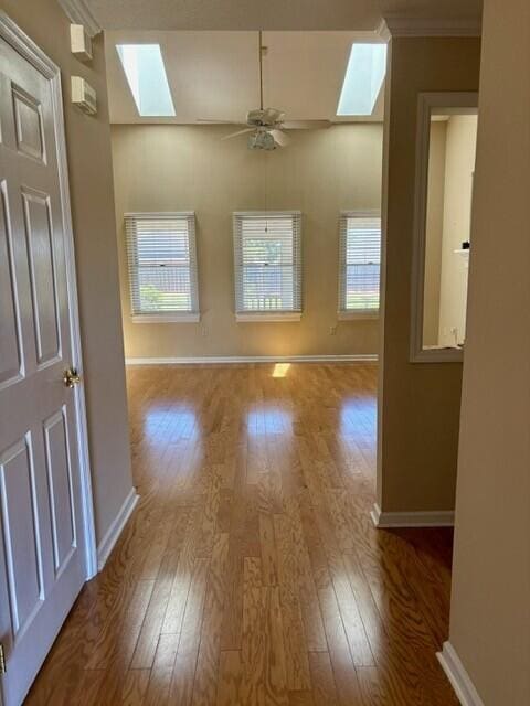 2949 Hillcreek Dr, Augusta, GA 30909 - unfurnished room with a skylight, baseboards, wood finished floors, plenty of natural light, and crown molding