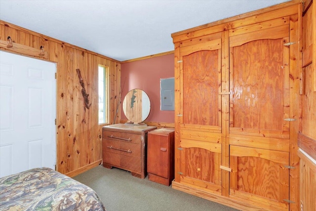 carpeted bedroom with wood walls, ornamental molding, and electric panel