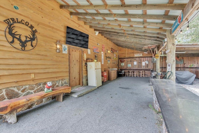 misc room with carpet and lofted ceiling