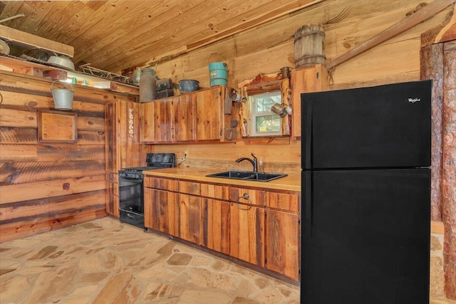 kitchen with black appliances, wooden ceiling, sink, and wooden walls