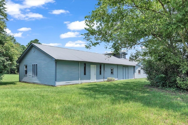 rear view of house with a yard