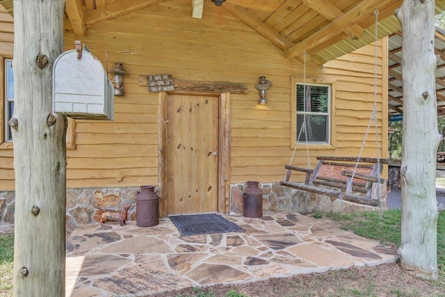 view of exterior entry featuring a patio