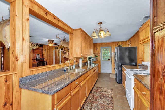 kitchen with ceiling fan with notable chandelier, sink, wood walls, white electric range, and light tile patterned flooring