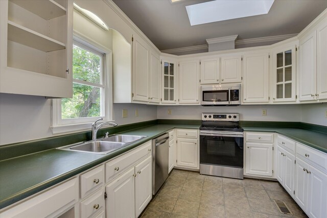 227 Water Oak Dr, Augusta, GA 30904 - kitchen featuring stainless steel appliances, a skylight, a sink, white cabinets, and ornamental molding