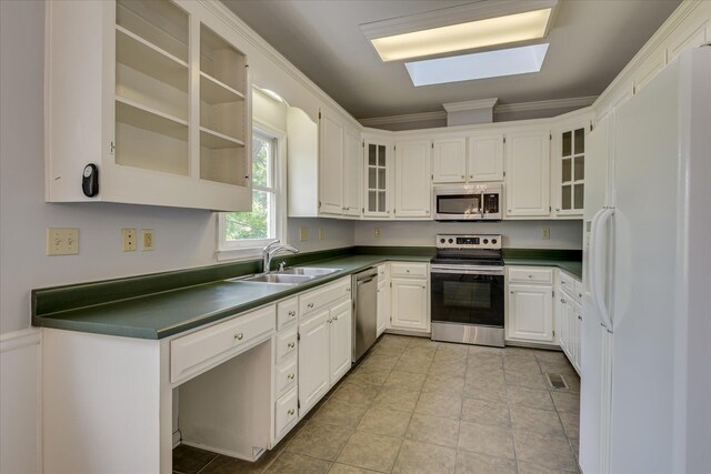 227 Water Oak Dr, Augusta, GA 30904 - kitchen featuring appliances with stainless steel finishes, a sink, ornamental molding, and white cabinetry
