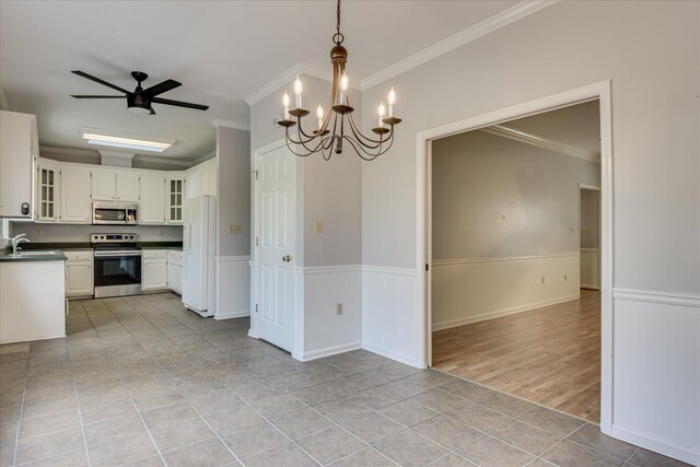 227 Water Oak Dr, Augusta, GA 30904 - kitchen with stainless steel appliances, a sink, dark countertops, white cabinets, and crown molding