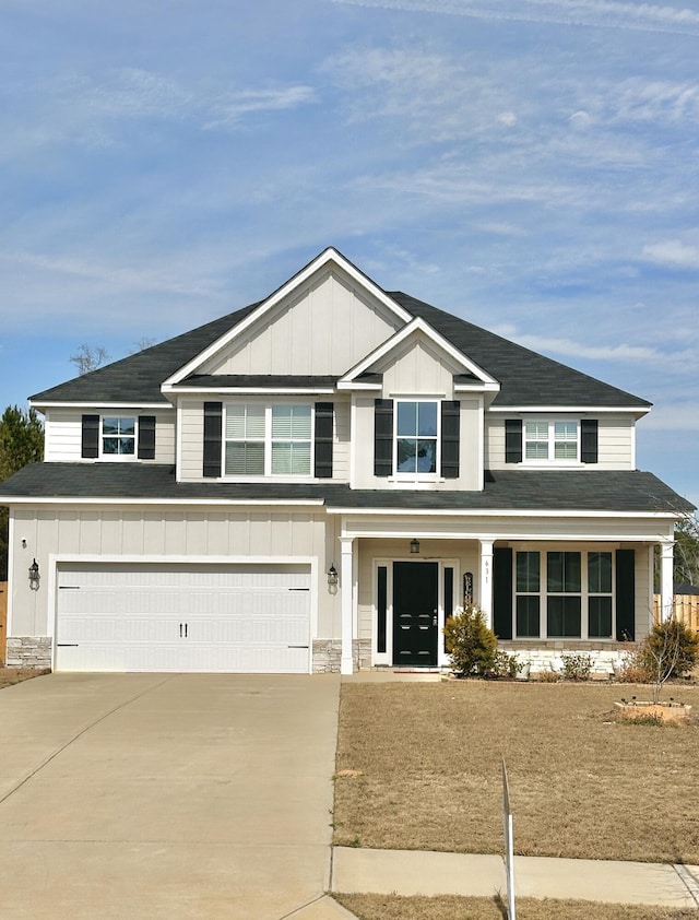 craftsman house with a garage, stone siding, board and batten siding, and concrete driveway