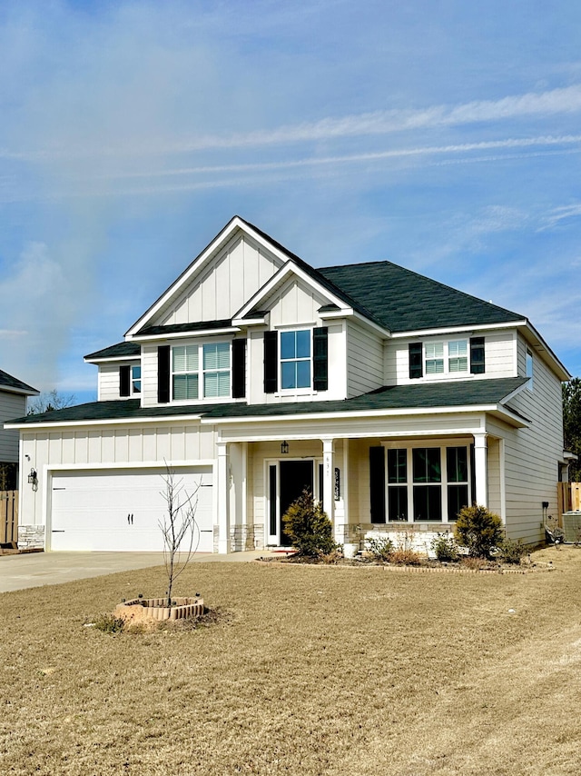 view of front of property with driveway, a garage, board and batten siding, and a front yard