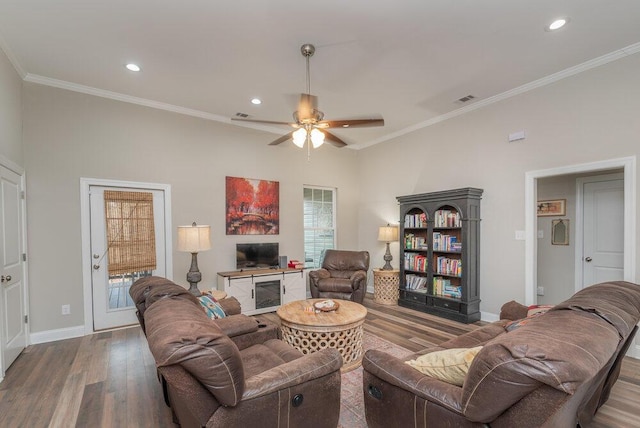 living room with ornamental molding, hardwood / wood-style floors, and ceiling fan