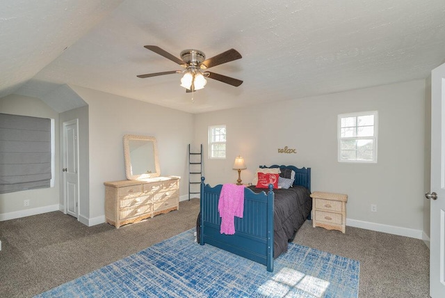 bedroom with multiple windows, ceiling fan, carpet floors, and a textured ceiling