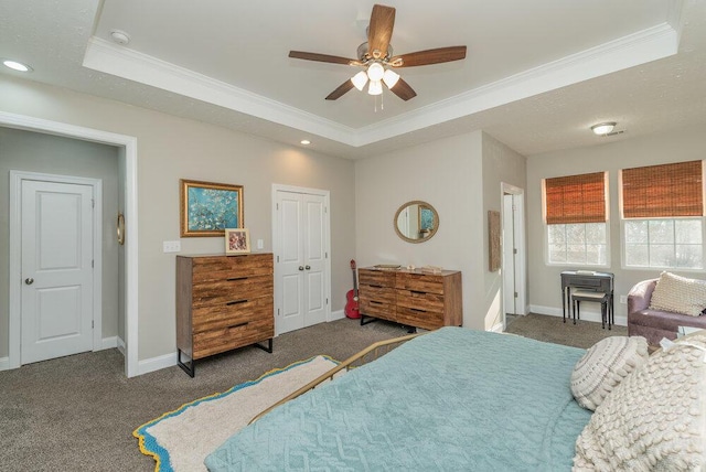 carpeted bedroom featuring ceiling fan, ornamental molding, a raised ceiling, and a closet