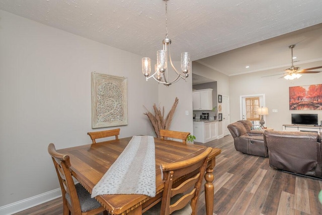 dining room featuring ceiling fan with notable chandelier, dark hardwood / wood-style floors, and a textured ceiling