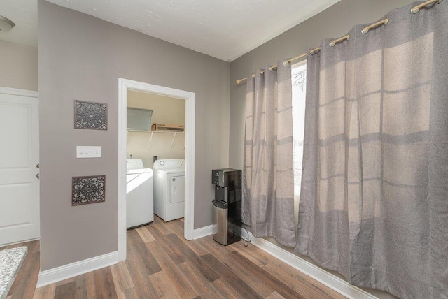 laundry room with hardwood / wood-style floors and washer and dryer