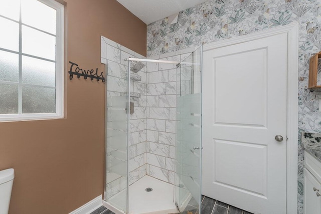 bathroom with toilet, a wealth of natural light, and walk in shower