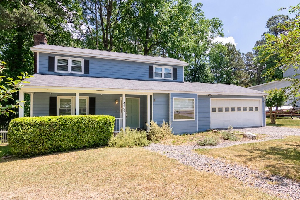 front facade with a front yard and a garage