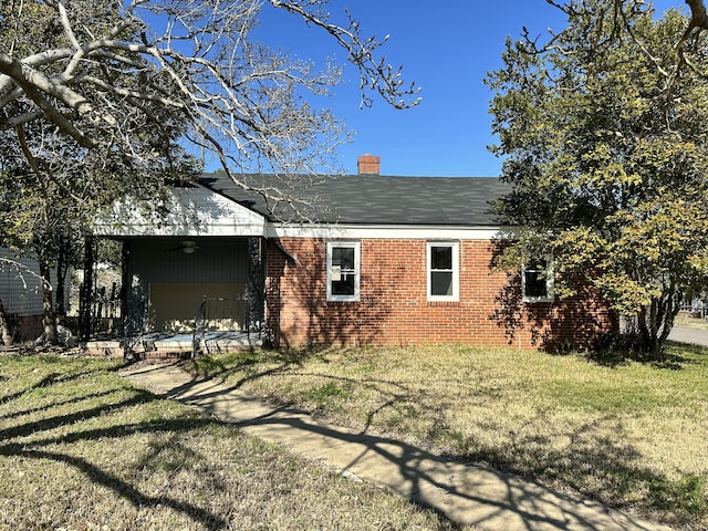 rear view of house with a lawn