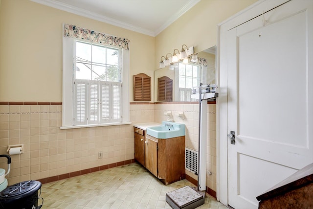 1203 Highland Ave, Augusta, GA 30904 - bathroom featuring tile walls, vanity, crown molding, tile patterned flooring, and wainscoting