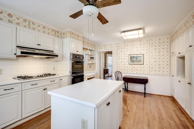 1203 Highland Ave, Augusta, GA 30904 - kitchen with under cabinet range hood, white gas cooktop, light wood-type flooring, ceiling fan, and crown molding