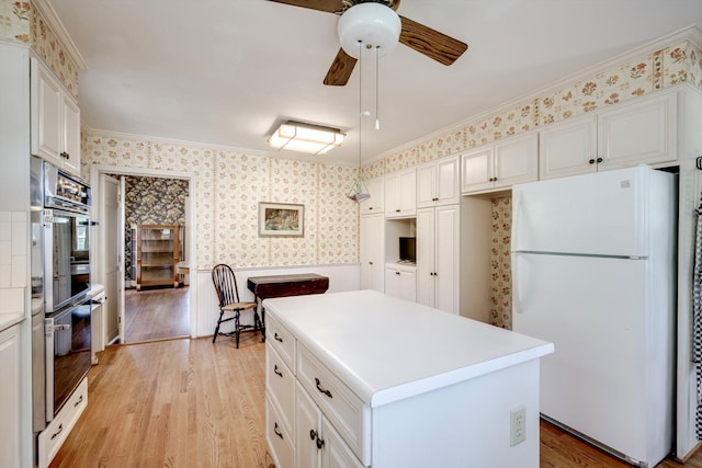 1203 Highland Ave, Augusta, GA 30904 - kitchen with freestanding refrigerator, ceiling fan, wallpapered walls, ornamental molding, and light wood finished floors