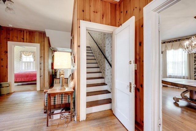 1203 Highland Ave, Augusta, GA 30904 - staircase with healthy amount of natural light, wooden walls, a chandelier, and wood finished floors