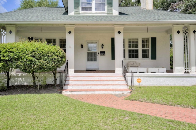1203 Highland Ave, Augusta, GA 30904 - doorway to property featuring a porch, roof with shingles, a lawn, and stucco siding
