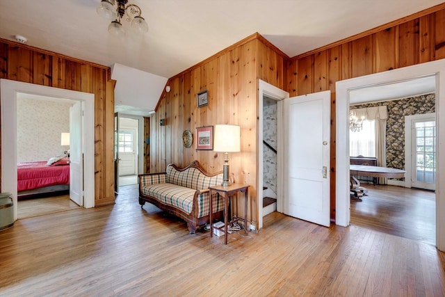 1203 Highland Ave, Augusta, GA 30904 - sitting room with a chandelier, light wood finished floors, wooden walls, stairway, and wallpapered walls