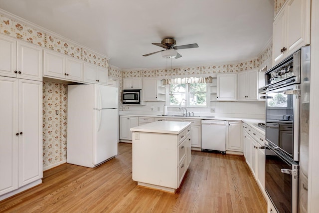 1203 Highland Ave, Augusta, GA 30904 - kitchen with appliances with stainless steel finishes, ceiling fan, open shelves, light wood-type flooring, and white cabinetry