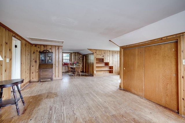 1203 Highland Ave, Augusta, GA 30904 - unfurnished living room with light wood-style flooring, stairway, and wooden walls
