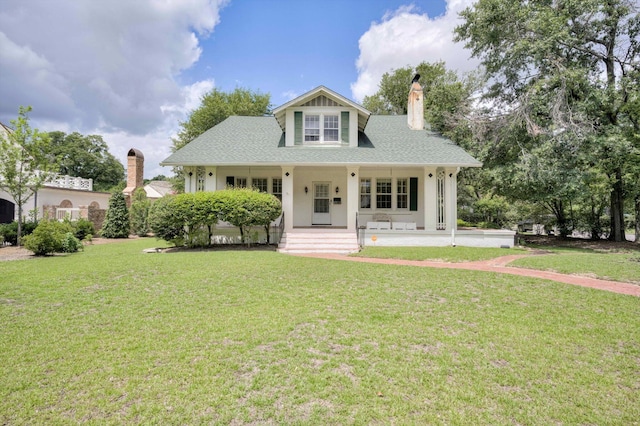 1203 Highland Ave, Augusta, GA 30904 - view of front of house with a chimney, a front yard, covered porch, and roof with shingles