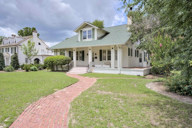 1203 Highland Ave, Augusta, GA 30904 - view of front of property with a front yard, a porch, roof with shingles, and a chimney