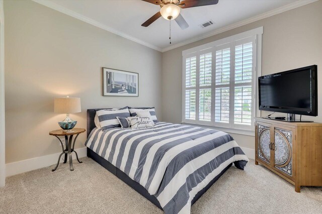 bedroom with ceiling fan, crown molding, and light colored carpet