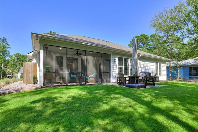 back of property featuring a sunroom and a yard