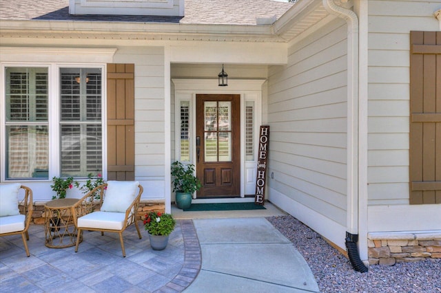 view of exterior entry with covered porch