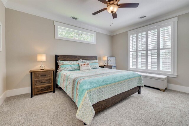 carpeted bedroom with ceiling fan and crown molding